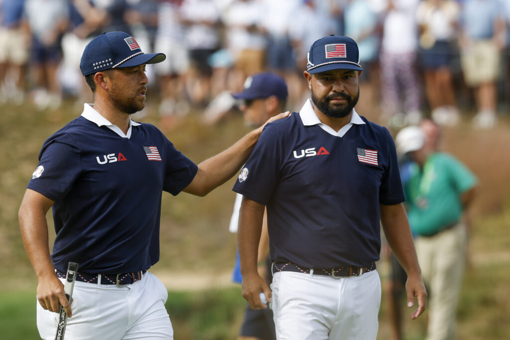 Xander Schauffele and J.J. Spaun of Team United States walk on the green at the 2025 Ryder Cup.