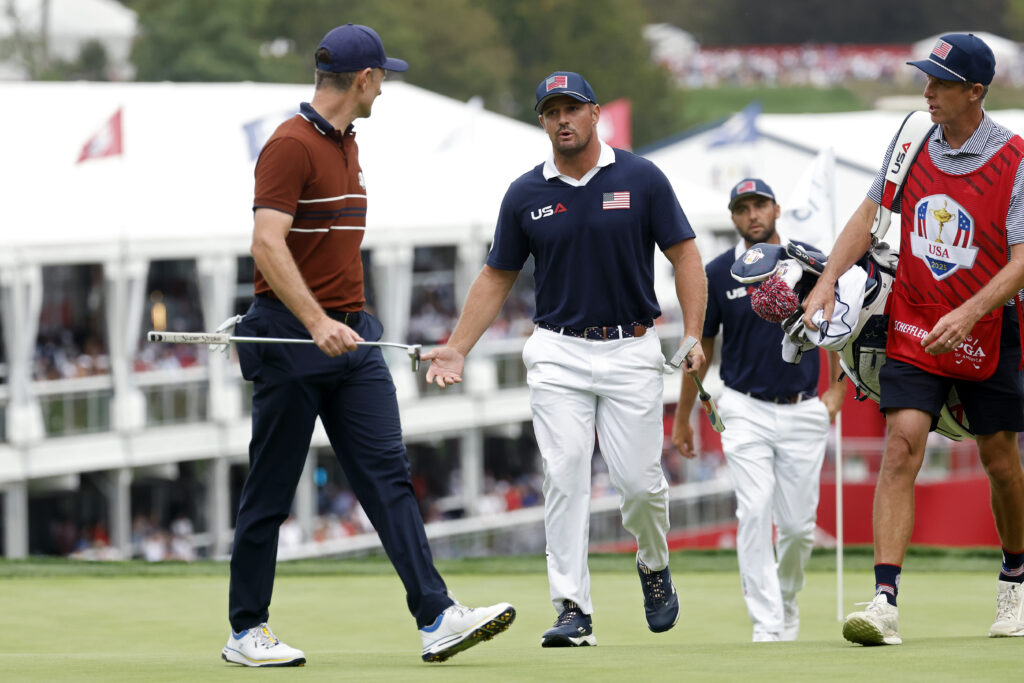 Justin Rose of Team Europe and Bryson DeChambeau of Team United States exchange words