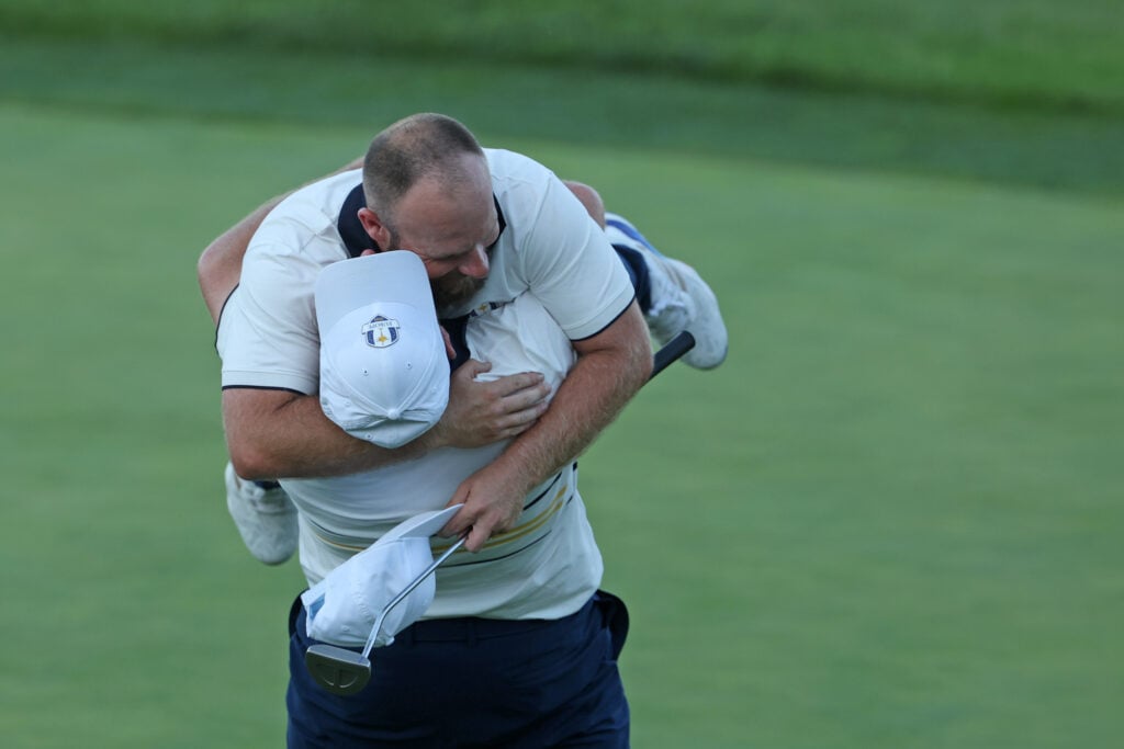 Shane Lowry lifts Tyrrell Hatton on the 18th green on Ryder Cup Sunday at Bethpage Black