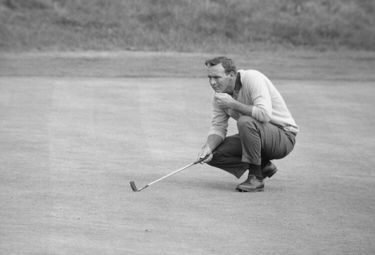 Arnold Palmer of the USA lines up a putt during the 1963 Open Championship at Royal Lytham & St Annes Golf Club in Lytham St Annes, England