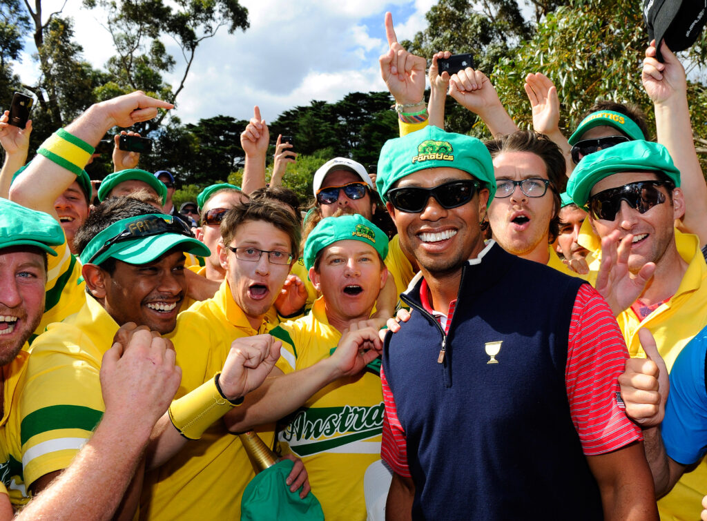 Tiger Woods of the U.S. Team celebrates with Aussie fans on the 17th hole after the Day Four Singles Matches of the 2011 Presidents Cup