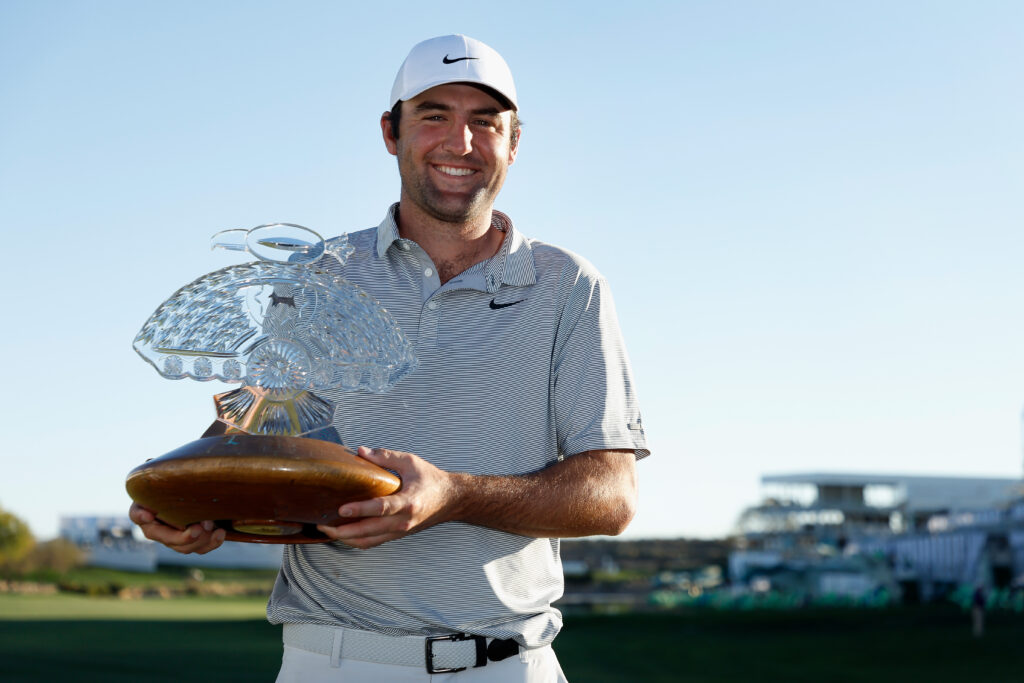 Scottie Scheffler lifts the trophy after winning the 2022 WM Phoenix Open