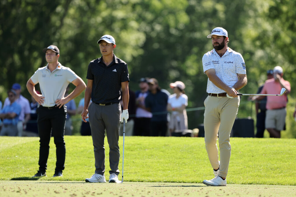 Cameron Young plays his shot from the 13th tee as Viktor Hovland and Collin Morikawa look on at the Wells Fargo at Quail Hollow