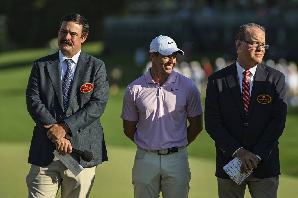 Rory McIlroy stands next to Johnson Wagner during the trophy ceremony following his Wells Fargo Championship victory at Quail Hollow