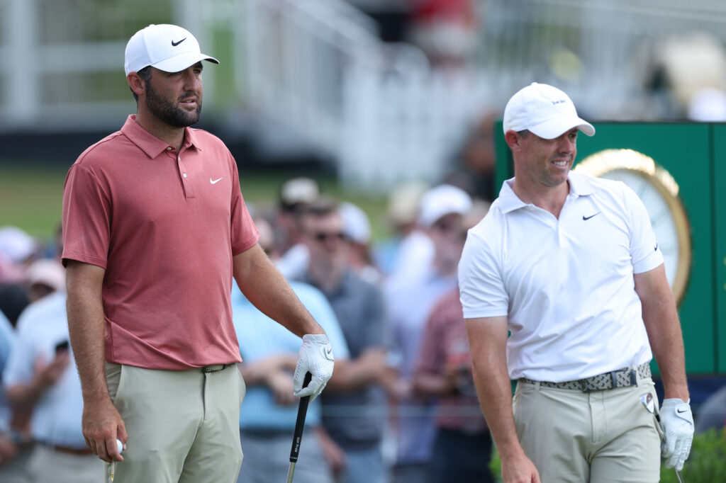 Scottie Scheffler and Rory McIlroy look on from the ninth tee during the first round of the TOUR Championship at East Lake
