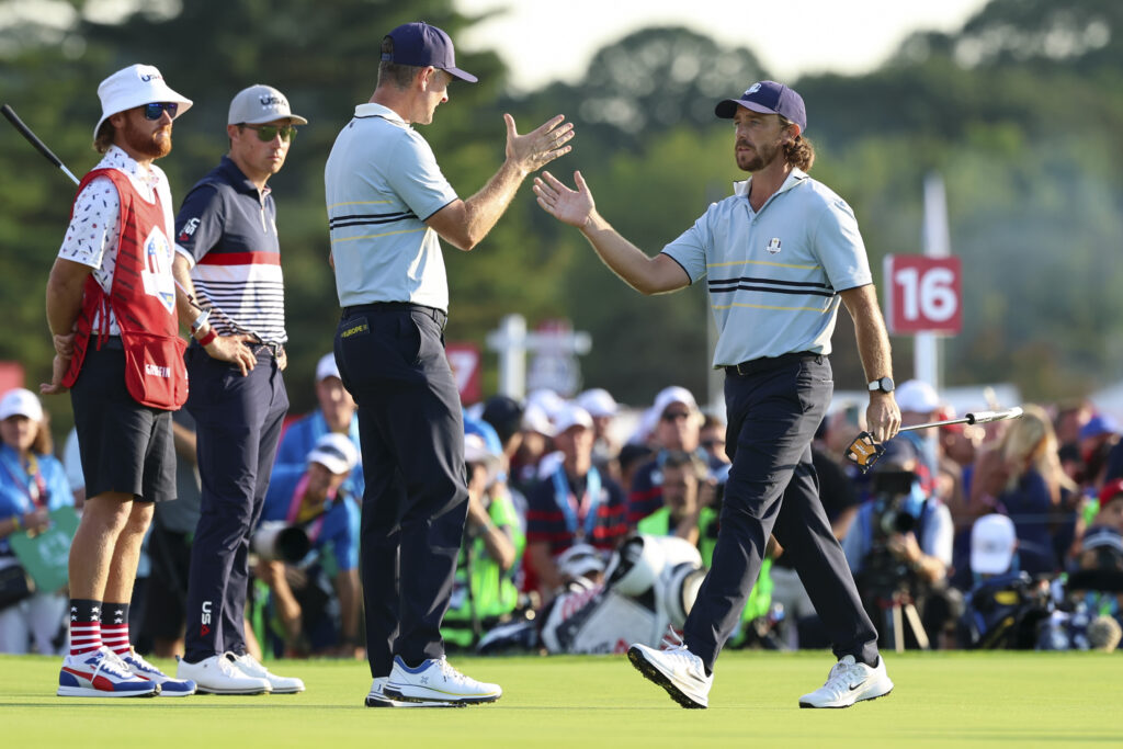 Justin Rose and Tommy Fleetwood high five during their match on Friday afternoon at the Ryder Cup