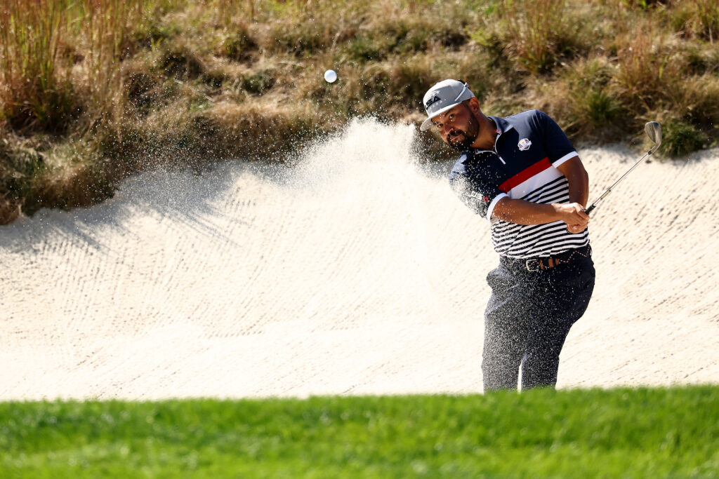 J.J. Spaun hits a bunker shot during the Friday afternoon session at the 2025 Ryder Cup