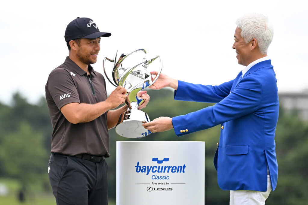 Xander Schauffele is presented with the trophy after winning the Baycurrent Classic
