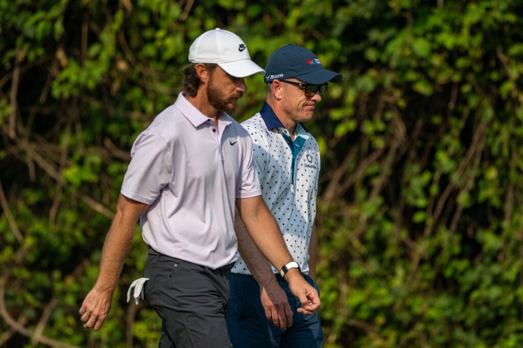Tommy Fleetwood of England and Luke Donald of England walk together at the DP World India Championship 2025