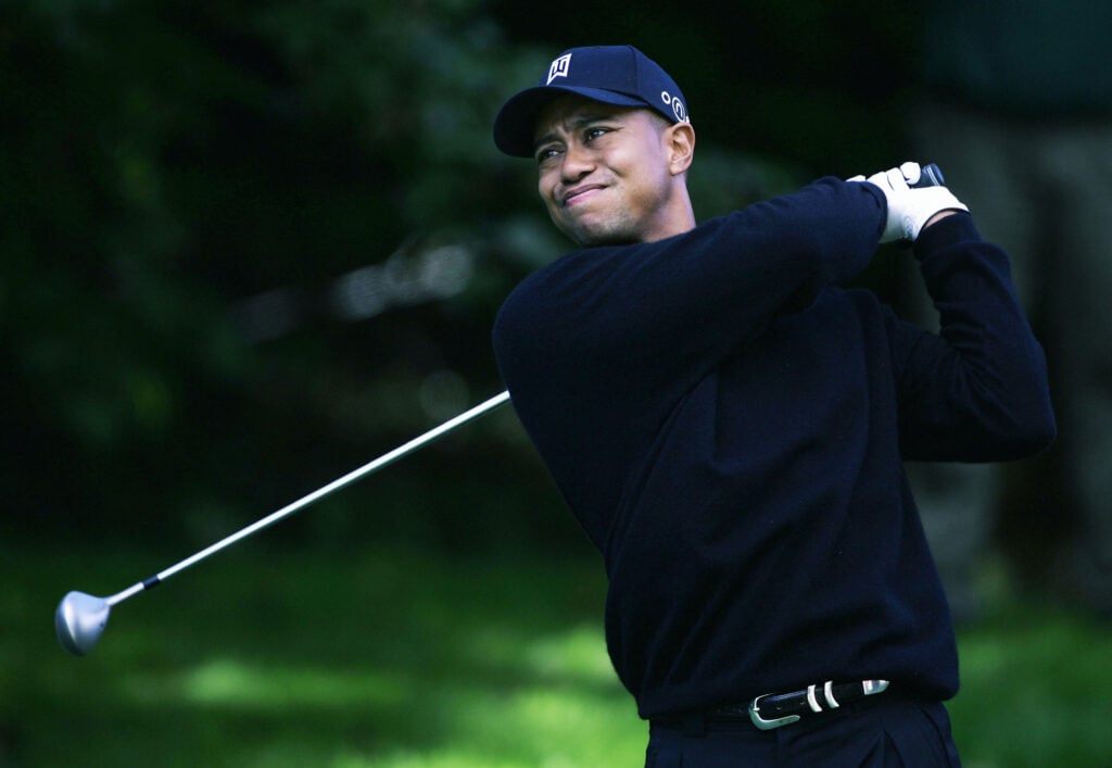 Tiger Woods of the U.S. tees off on whilst struggling with a back injury