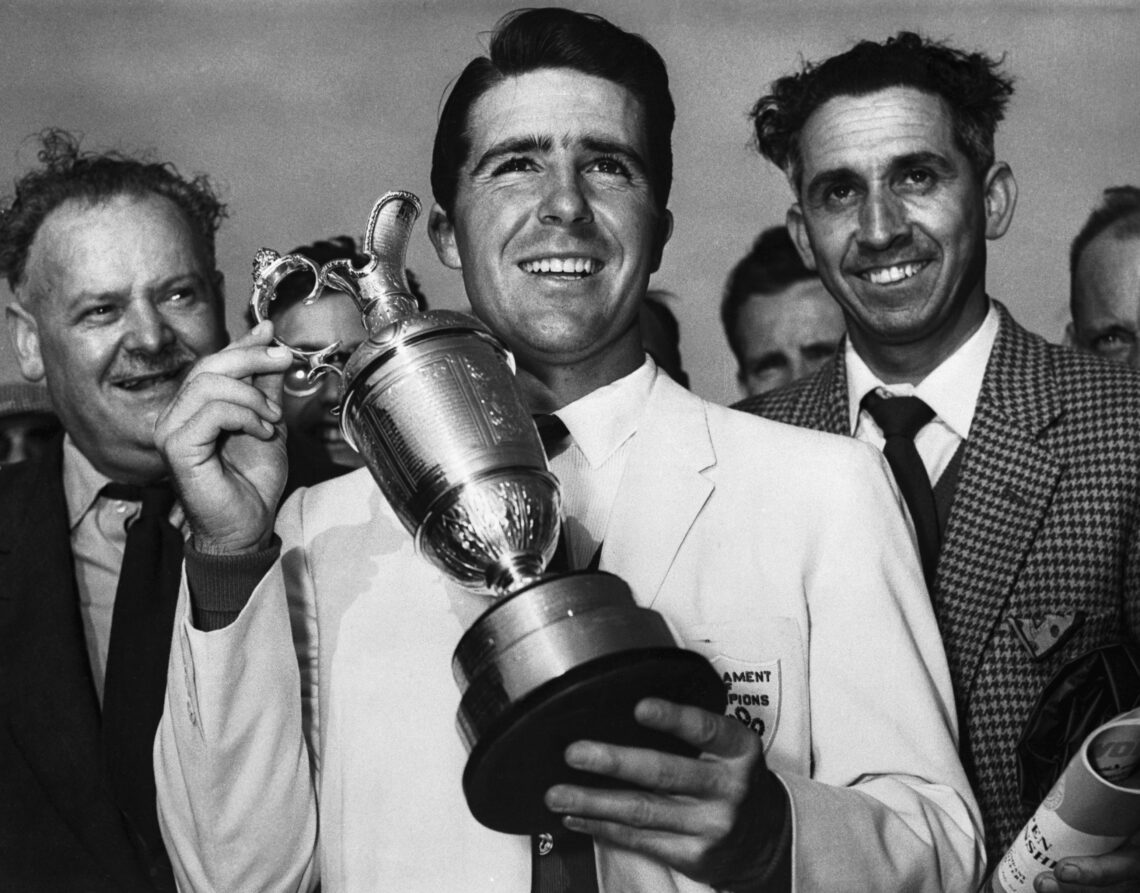 (Original Caption) Holding up his trophy, Gary Player (center), winner of the British Open Golf Championship, smiles here, July 3rd. Player, 23, co...