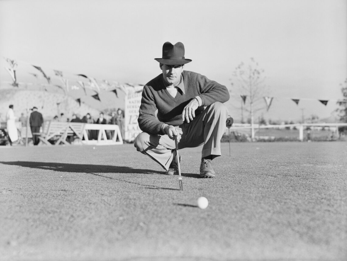 Professional golfer Harry Cooper squatting on the golf course during the final round of the 1937 Los Angeles Open Tournament in California on Janua...