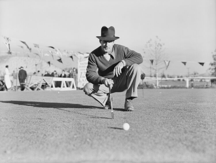 Professional golfer Harry Cooper squatting on the golf course during the final round of the 1937 Los Angeles Open Tournament in California on Janua...