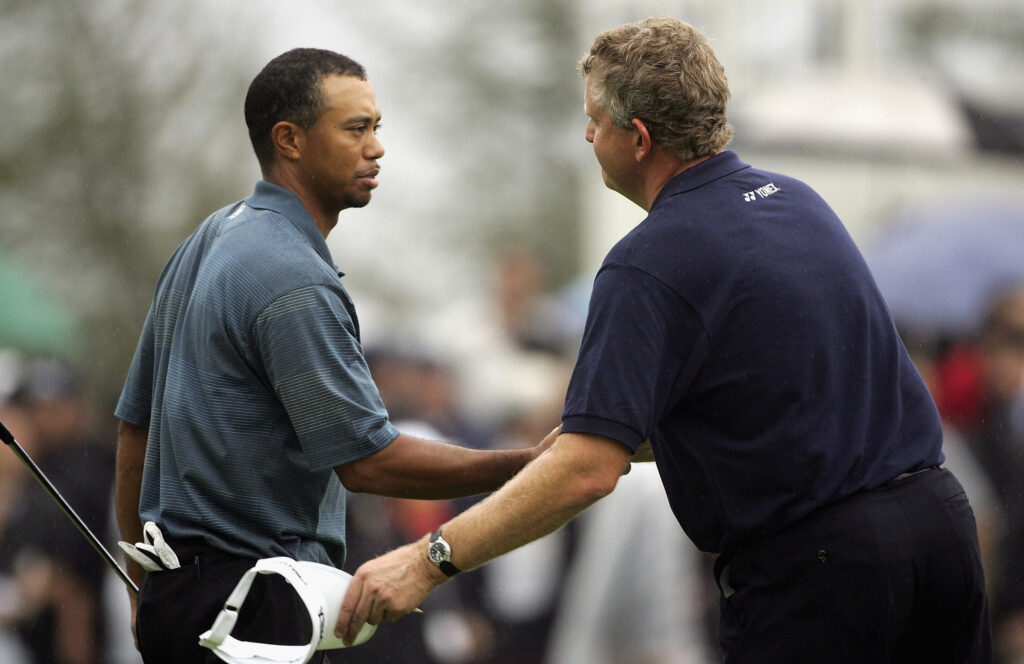 Tiger Woods and Colin Montgomerie shake hands after the first round of HSBC Championships in 2005