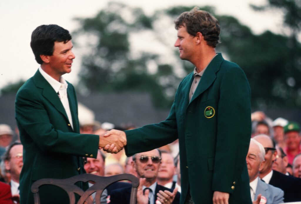 1987 Masters Champion Larry Mize shakes hands with 1988 Masters Champion Sandy Lyle