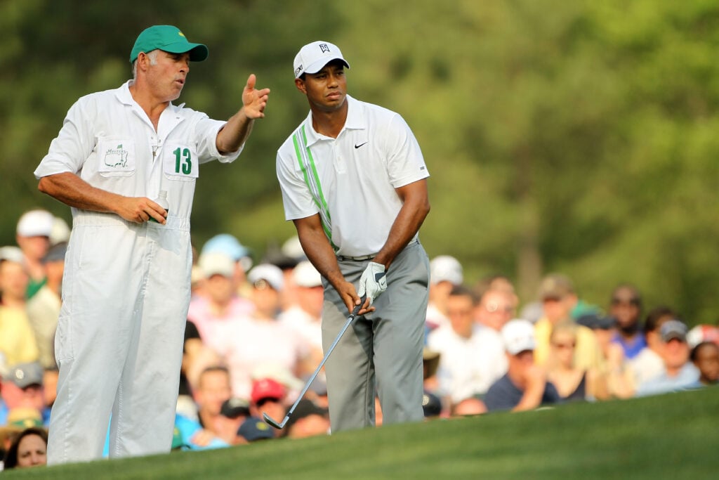 Tiger Woods talks with caddie Steve Williams on the second hole tee during the second round of the 2011 Masters Tournament