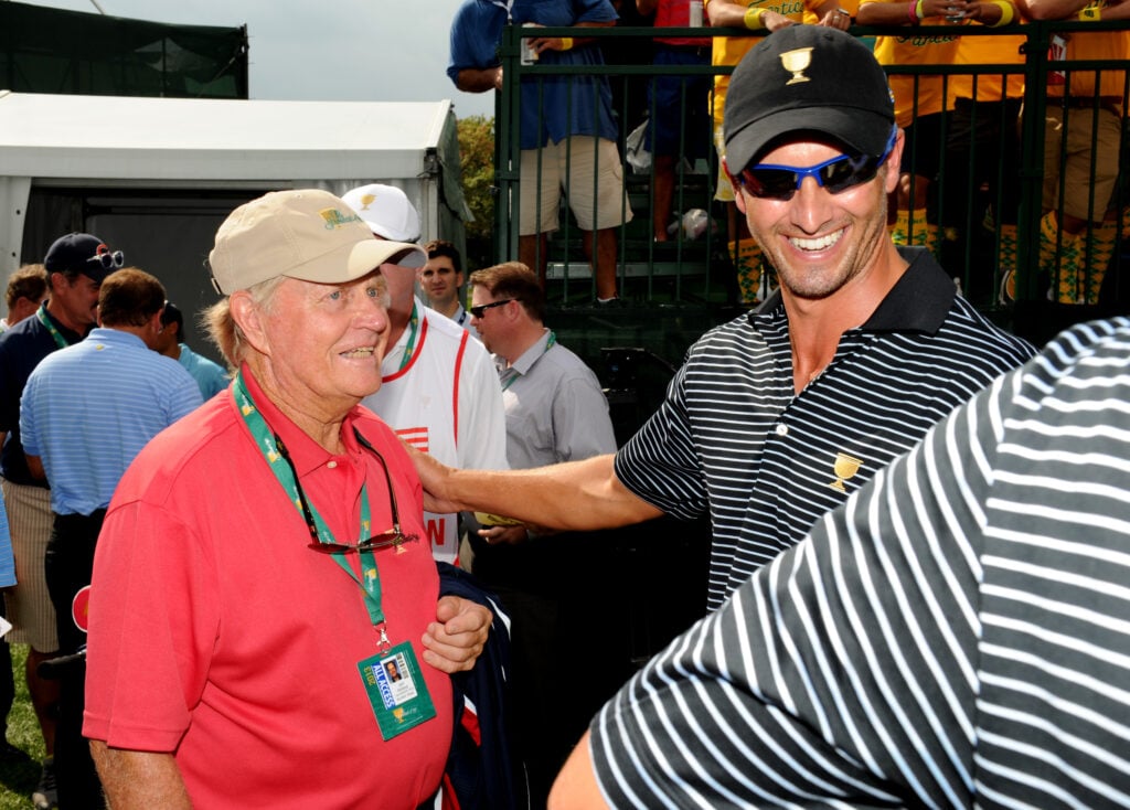 Adam Scott of the International Team speak with Presidents Cup host Jack Nicklaus in 2013
