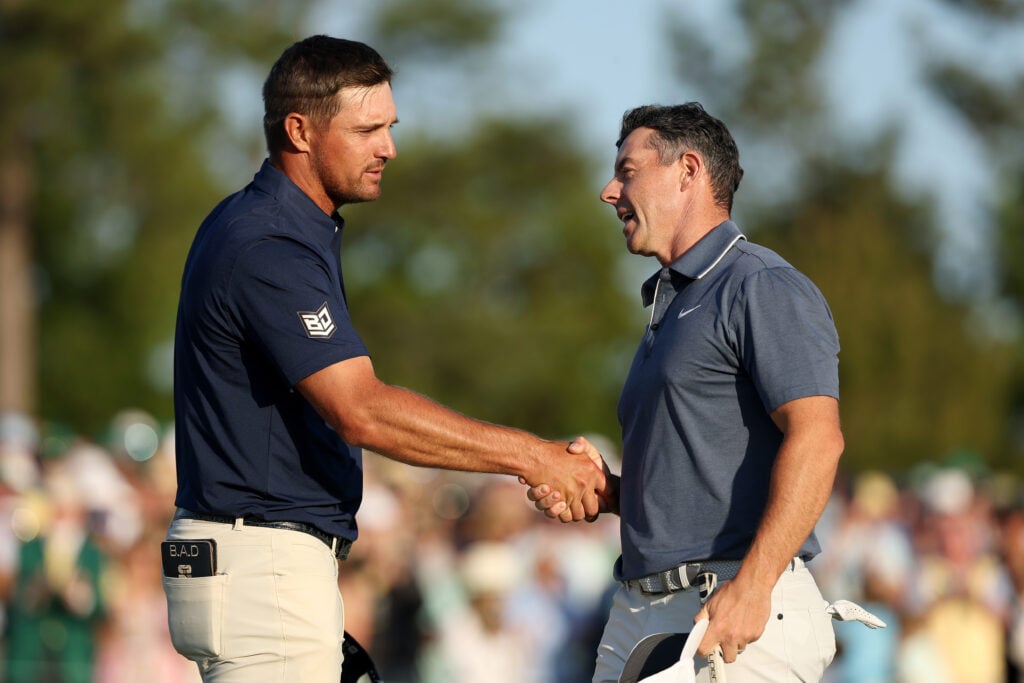 Rory McIlroy of Northern Ireland shakes hands with Bryson DeChambeau at the 2025 The Masters