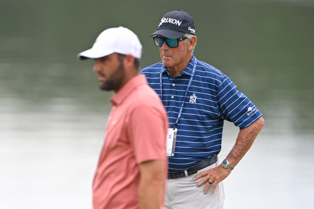 Scottie Scheffler works with his coach, Randy Smith, during the first round of the TOUR Championship 2025