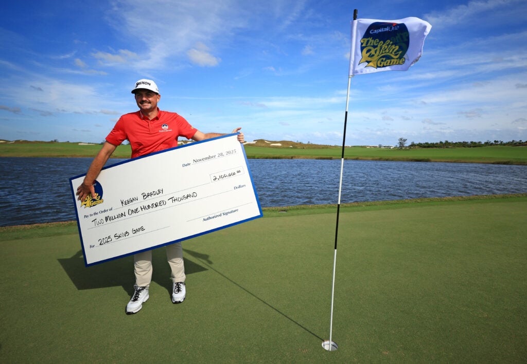 Keegan Bradley of the United States celebrates with his check after winning The Skins Game at Panther National
