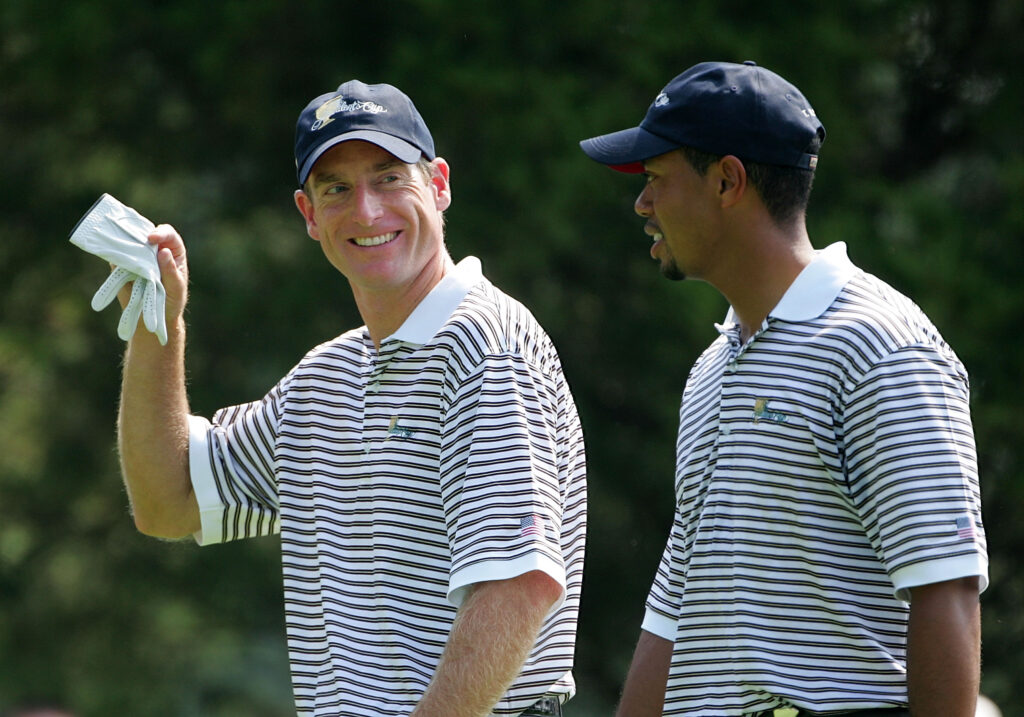 Jim Furyk talks with Tiger Woods during the second day of the 2005 Presidents Cup