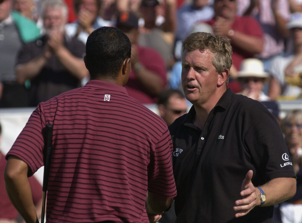 Tiger Woods and Colin Montgomerie shake hands during the final round of the Deutsche Bank SAP Open