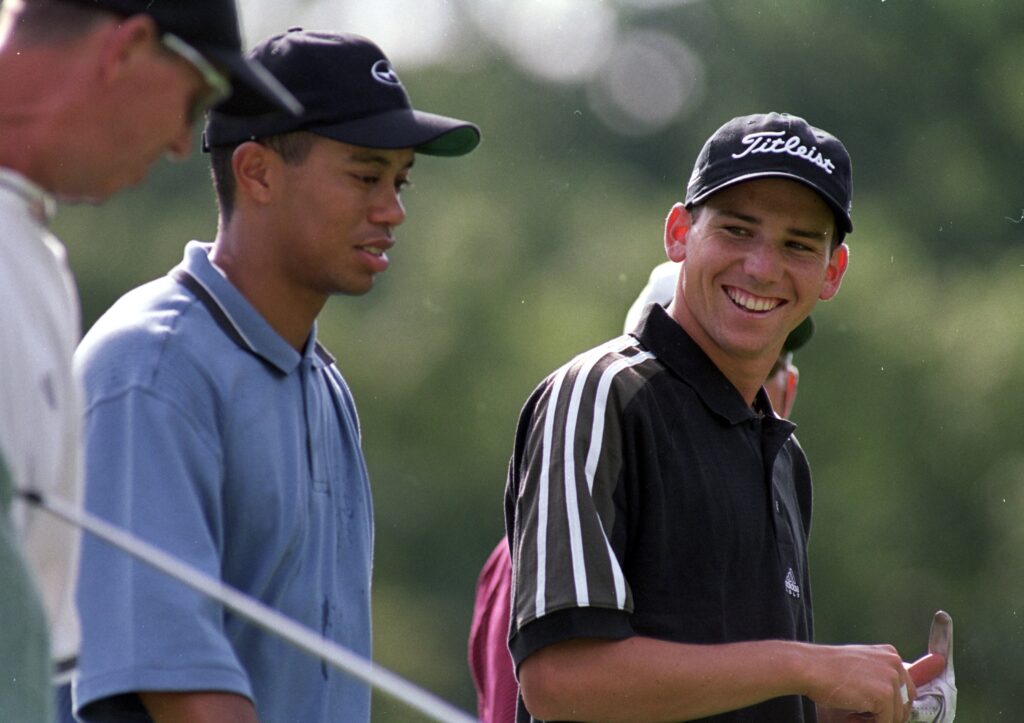 Sergio Garcia smiles at Tiger Woods as they walk together during the PGA Championships