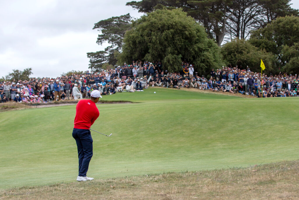 Tiger Woods hits a chip shot during the singles matches at the 2019 Presidents Cup