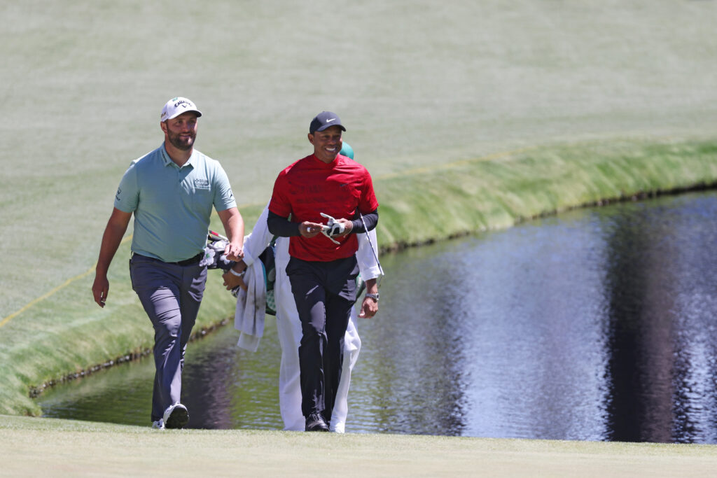 Jon Rahm and Tiger Woods walk to the 16th green during the final round of The Masters