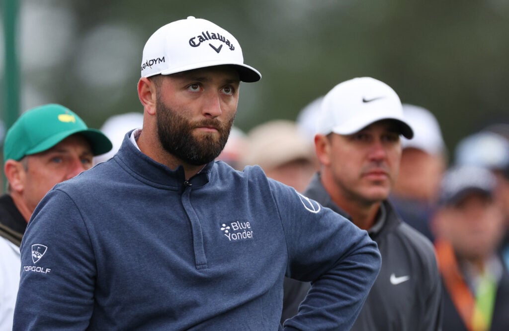 Jon Rahm of Spain and Brooks Koepka of the United States look on from the eighth tee during the continuation of the weather delayed third round of the 2023 Masters Tournament