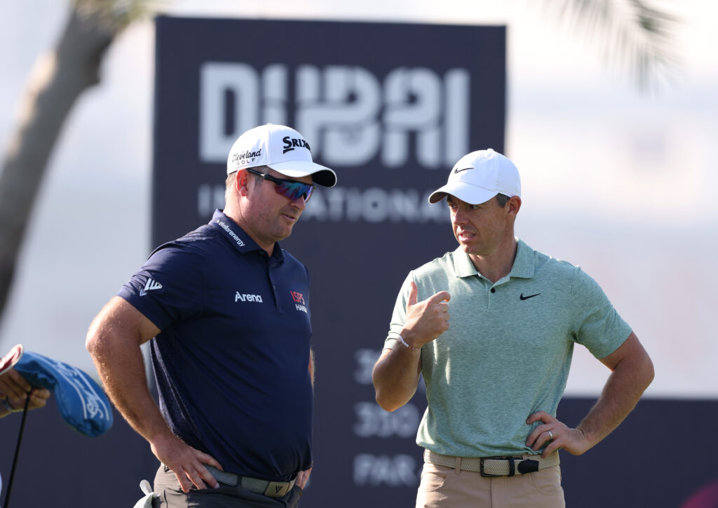 Rory McIlroy and Ryan Fox speak during the first round of the Dubai Invitational