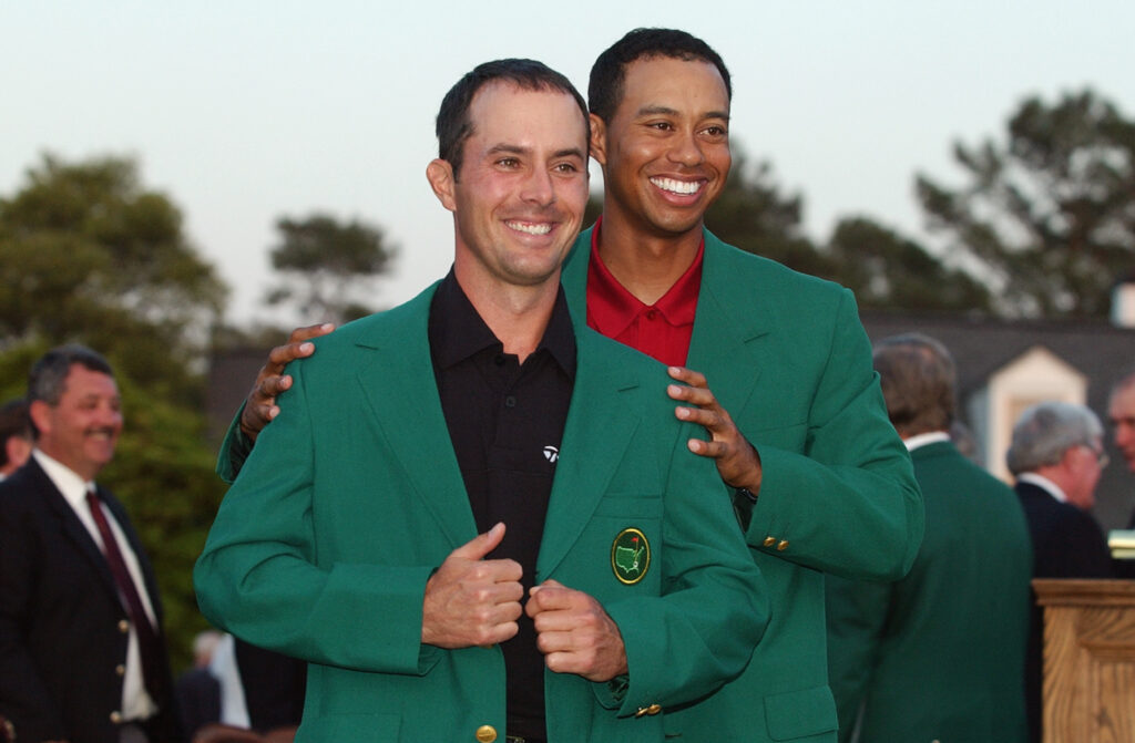 Tiger Woods presents Mike Weir with his green jacket after winning the 2003 Masters