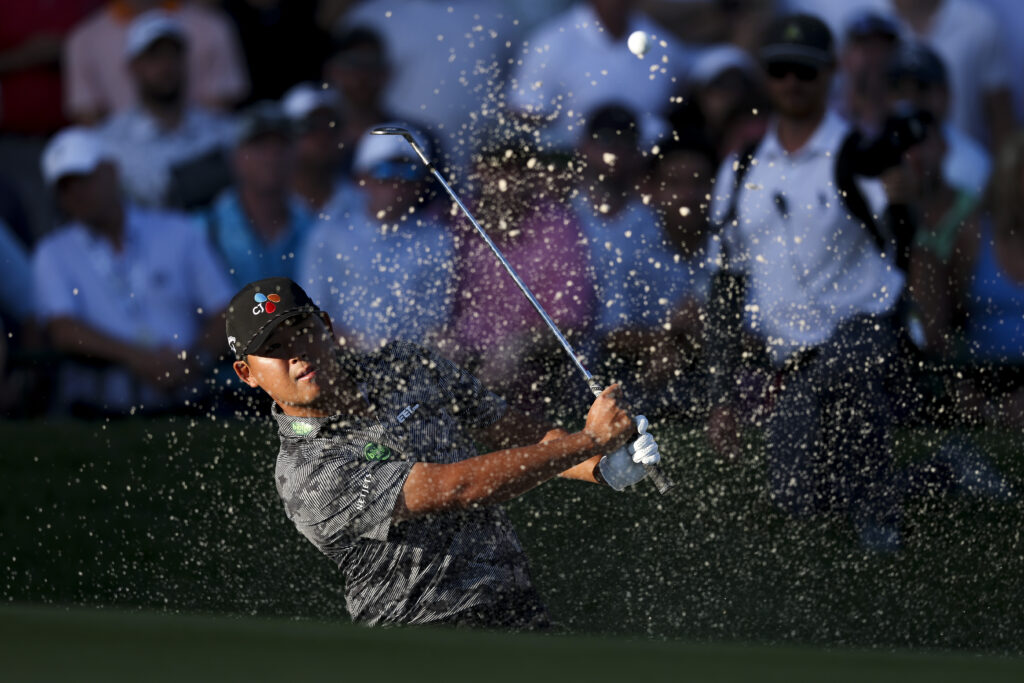 Si Woo Kim of South Korea plays a shot from the bunker on the 18th hole during the third round of the PGA Championship 2025
