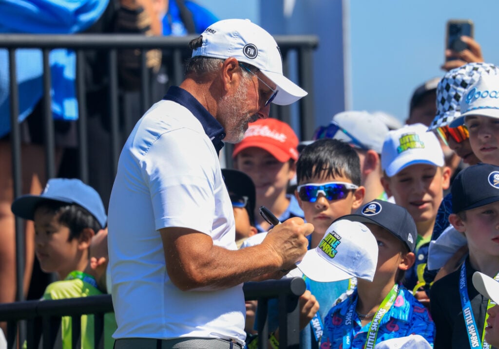 Phil Mickelson signs hats for fans during the LIV Golf event in Dallas