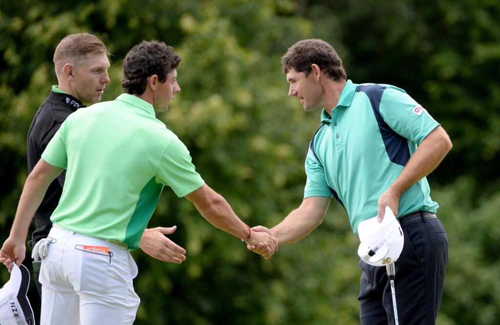 Rory McIlroy of Northern Ireland and Padraig Harrington of Ireland shake hands during the first round of the Irish Open at the Fota Island Resort on June 19, 2014