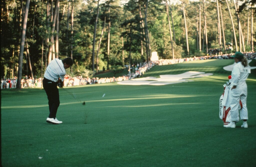 Sir Nick Faldo hits his approach into the 10th hole during the final round of the 1990 Masters Tournament