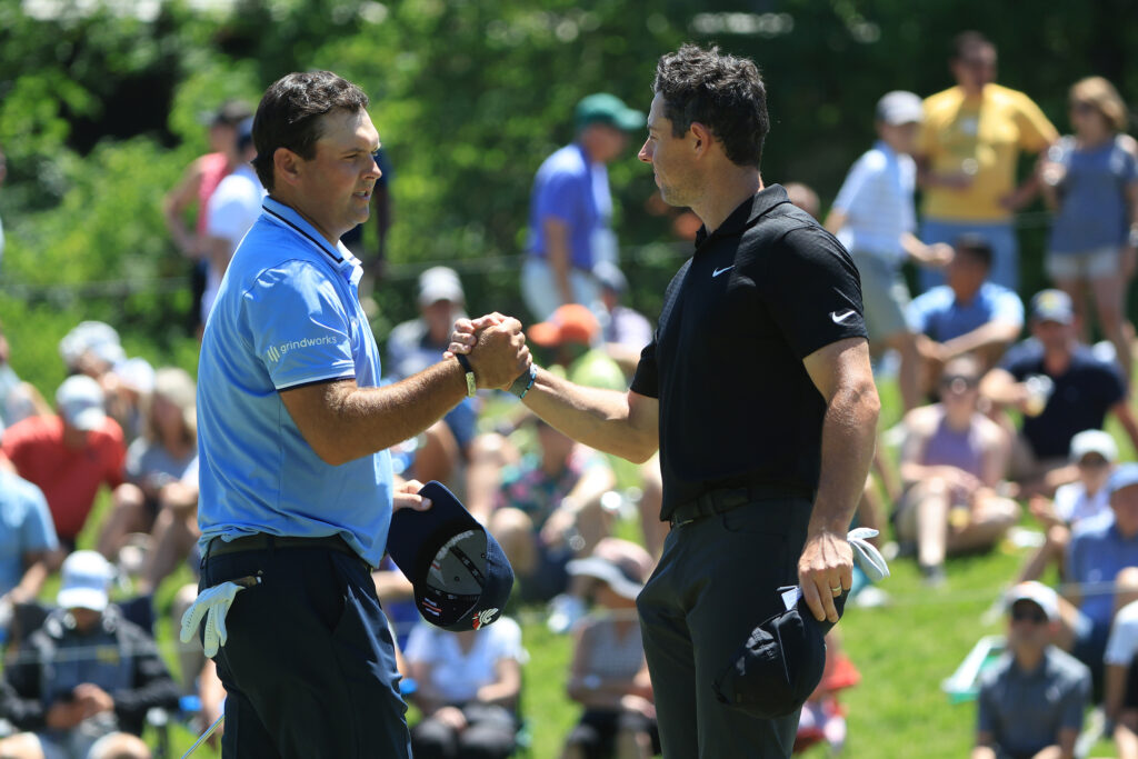 Rory McIlroy and Patrick Reed shake hands after the second round of the Memorial Tournament