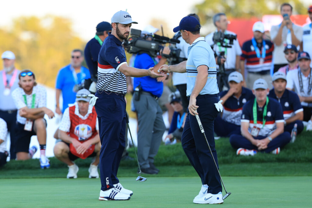 Rory McIlroy gives Patrick Cantlay his marker during their match on Friday afternoon at the Ryder Cup