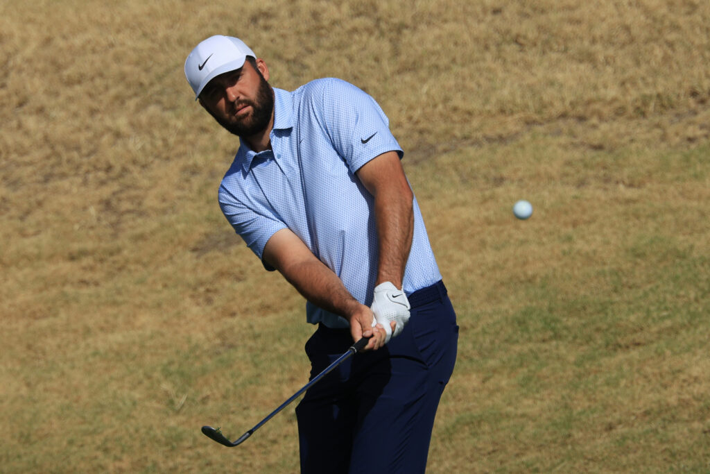 Scottie Scheffler chips onto the green during the final round of The American Express