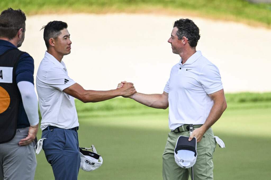Rory McIlroy shakes hands with Collin Morikawa on the 18th hole green during the first round of the Arnold Palmer Invitational