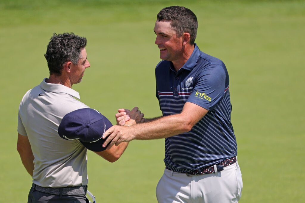 Rory McIlroy and Keegan Bradley shake hands after the first round of the Travelers Championship