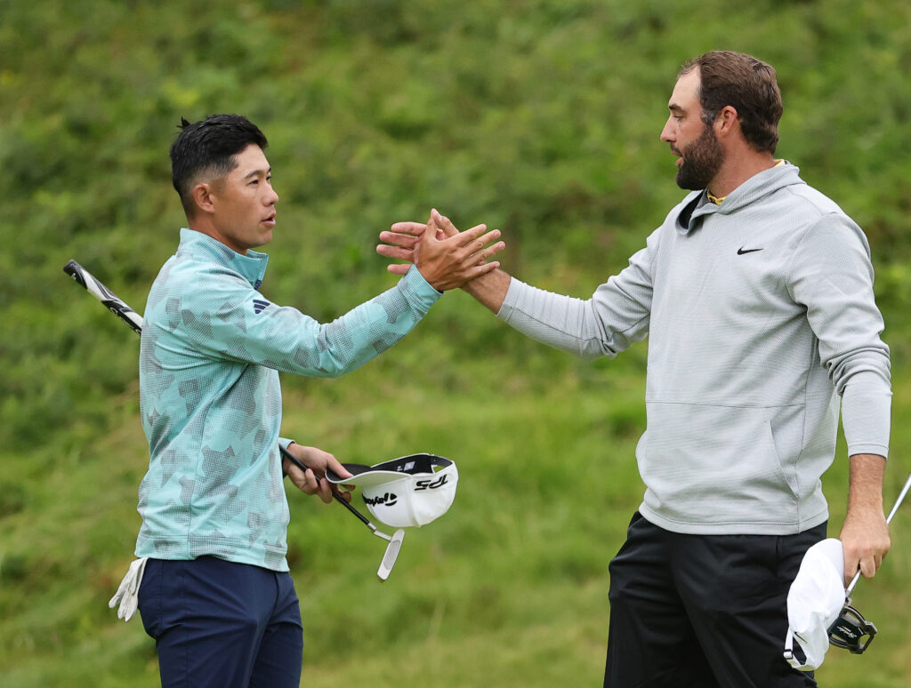 Collin Morikawa shakes hands with Scottie Scheffler after the second round of The 153rd Open Championship at Royal Portrush in 2025.