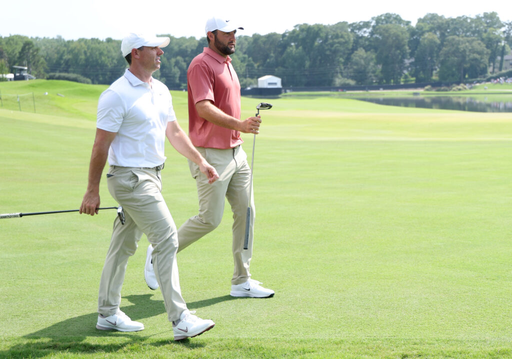 Scottie Scheffler and Rory McIlroy walk down to the green during the first round of the Tour Championship