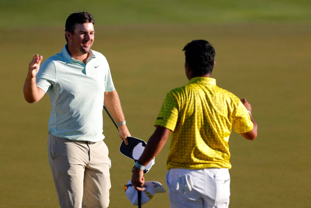 Chris Gotterup and Hideki Matsuyama on the 18th green of the first playoff hole after winning the WM Phoenix Open