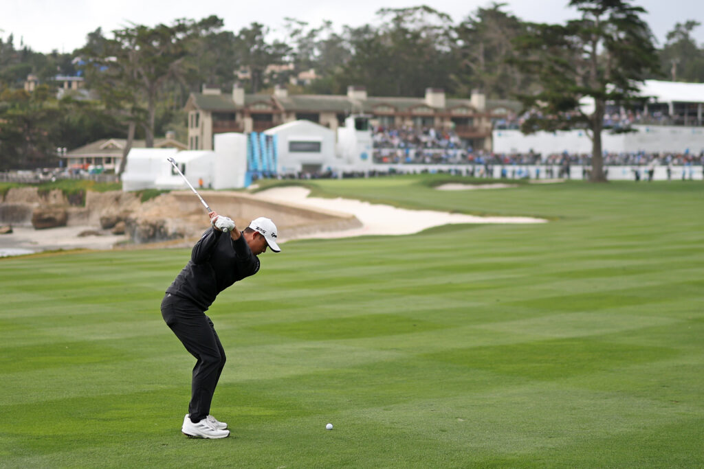 Collin Morikawa hits an approach into the final hole during the last round at the AT&T Pebble Beach Pro-Am