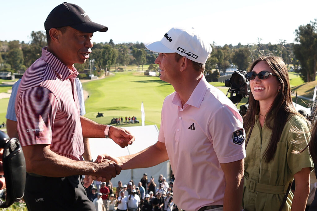 Tiger Woods and Jacob Bridgeman shake hands after Bridgeman wins the Genesis Invitational at Riviera