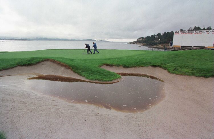 3 Feb 1996: Greenskeepers squeegee the waterlogged 18th green  at Pebble Beach Golf Course before  the third  round of the AT&T Pebble Beach Na...