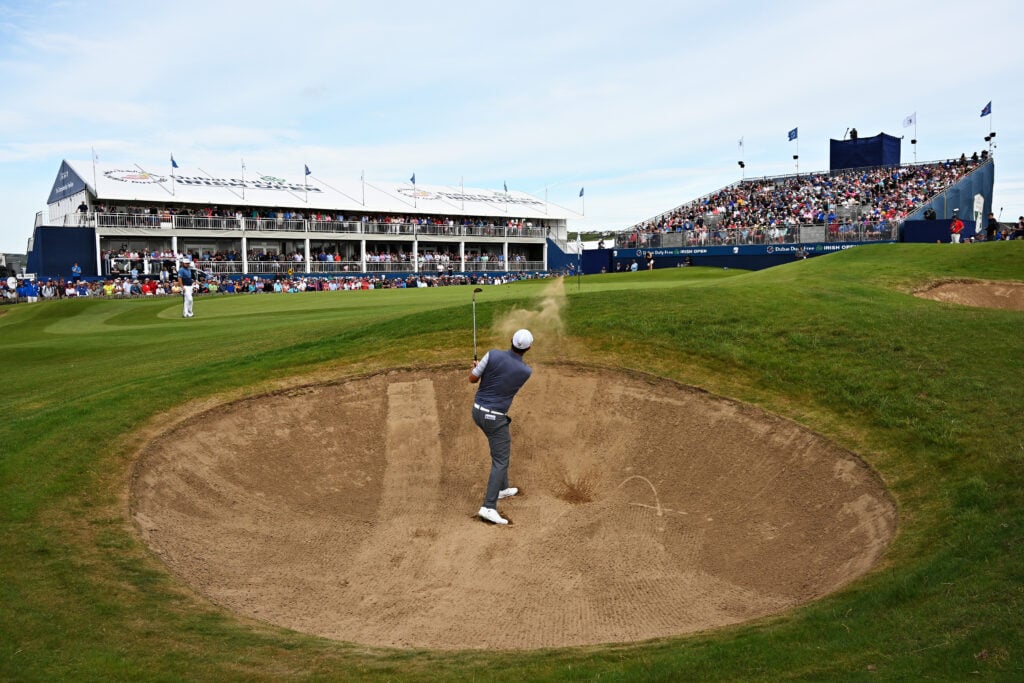 Padraig Harrington of Ireland plays his third shot from a bunker on the eighteenth hole during Day One of the Dubai Duty Free Irish Open at Lahinch Golf Club