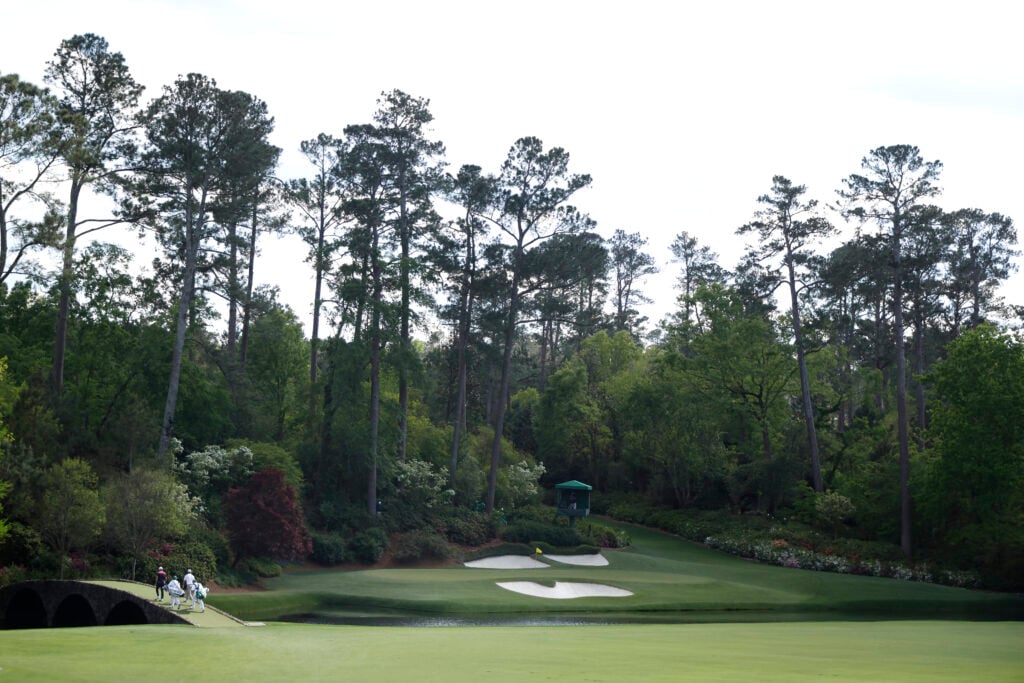 A general view as Viktor Hovland and Rasmus Hojgaard walk across the Hogan Bridge on the 12th hole during the third round of The Masters at Augusta National
