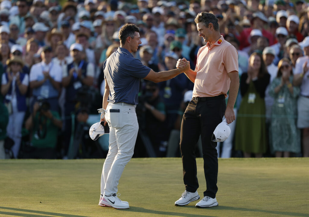 Rory McIlroy of Northern Ireland shakes hands with Justin Rose of England after the first playoff hole during the final round of the 2025 Masters Tournament at Augusta National